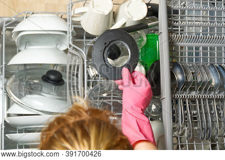 Dirty Dish In Open Integrated Dishwasher. Open Dishwasher With Dirty Dishes Inside Before Washing. F