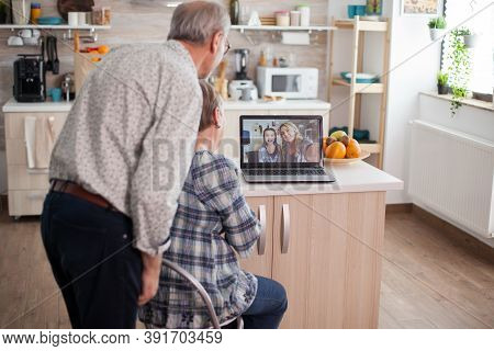 Senior Retired Couple Talking With Niece Via Internet Video Call. Online Call With Daughter And Niec