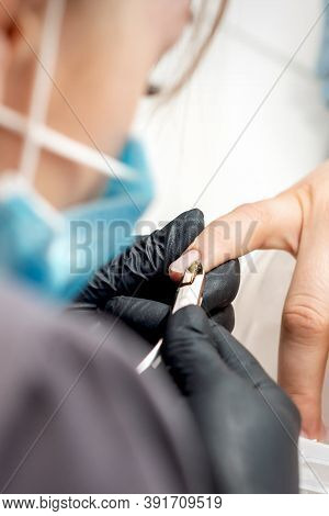 Manicure Master Removes Cuticles By Professional Nail Clipper Metal Tool On Female Nails In Nail Sal