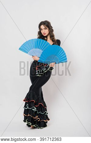 Portrait Of Beautiful Young Woman Dancing Flamenco In Studio