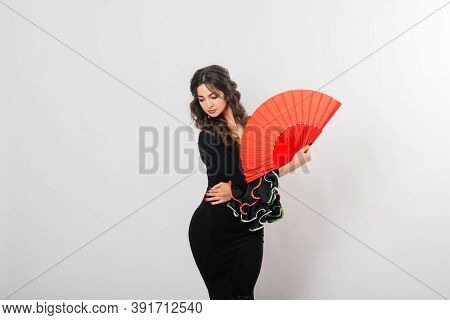 Portrait Of Beautiful Young Woman Dancing Flamenco In Studio
