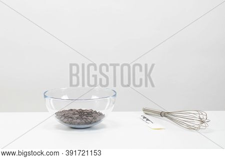 Closeup Dark Chocolate Drops Chips Morsels Callets In Glass Bowl, Isolated White Background. Prepara