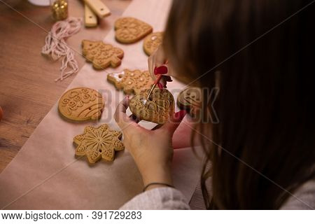 Christmas Baking. Brunette Young Woman Making Christmas Gingerbread With Icing And Confectionery Mas