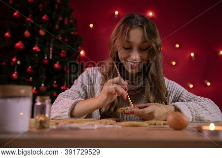 Portrait Of Pretty Smiling Brunette Girl Making Christmas Gingerbread In Xmas Decoration With Christ