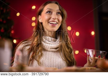 Christmas Baking. Pretty Brunette Young Woman Smiling Looking Away On Blurred Background Of Christma