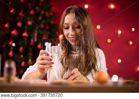 Portrait Of Pretty Smiling Brunette Girl Icing Christmas Gingerbread Making Handmade Festive New Yea