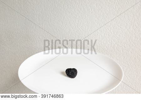 Expensive Rare Black Truffle Mushroom. French Black Perigord Truffle On White Plate