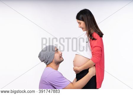 Young Future Dad Holding His Wife And Looking Her Face With Happy.
Husband Excited With Unborn Baby 