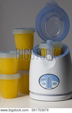 Digital Baby Food And Bottle Warmer With Open Lid And Storage Container In It On The White Backgroun
