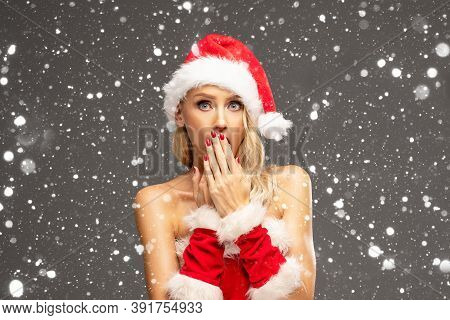 Beautiful Santa Girl, Caucasian Woman, In Red Hat Posing Over Snowfalkes.