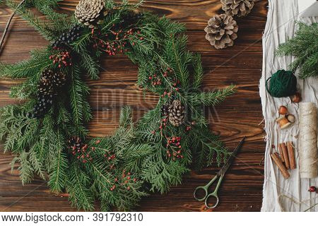Rustic Christmas Wreath On Wooden Table Flat Lay. Holiday Workshop