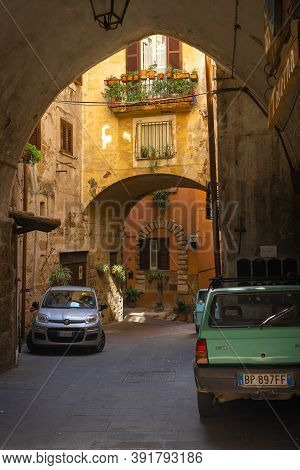 Modern Cars On Street Of  Medieval Town Of Orte In Italy.