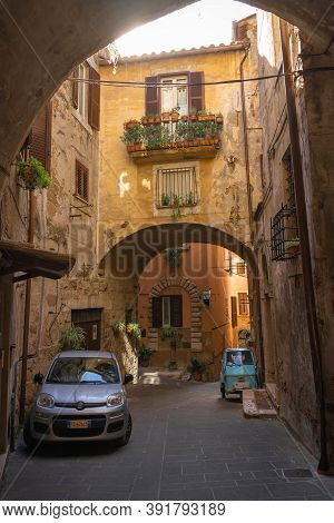 Modern Cars On Street Of  Medieval Town Of Orte In Italy.