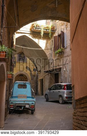 Modern Cars On Street Of  Medieval Town Of Orte In Italy.