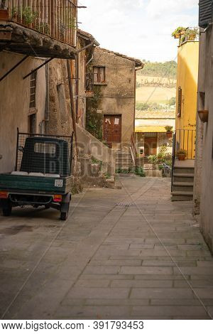 Modern Cars On Street Of  Medieval Town Of Orte In Italy.