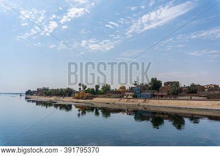 Traditional Egyptian Villages On The Bank Of The River Nile. Views Sailing On The Cruise On The Rive