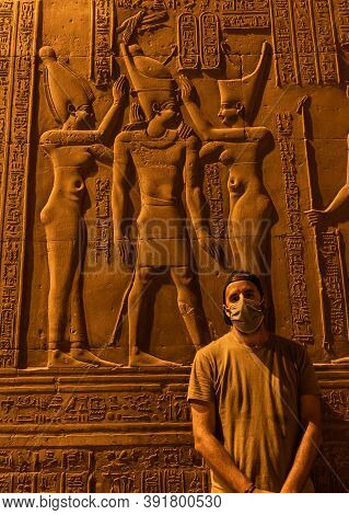 A Young Man With A Face Mask Visiting At Night The Beautiful Temple Of Kom Ombo, The Temple Dedicate