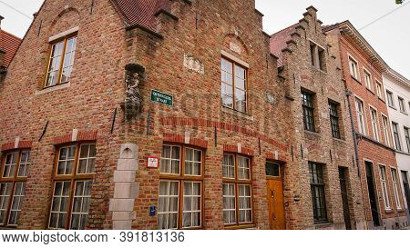 Bruges, Belgium - May 12, 2018:  Roofs And Windows Of Old Authentic Brick Houses On Street Ontvanger