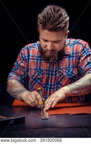 Craftsman Working With Leather Using Crafting Tools At His Shop