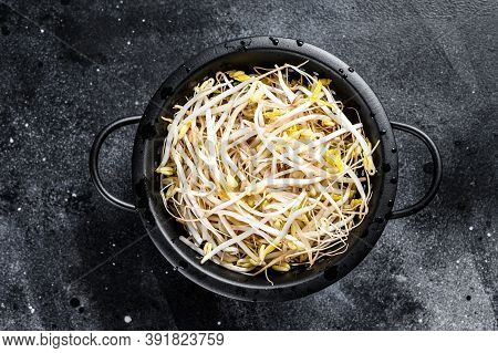 Sprouts Of Sprouted Beans In A Colander. Vegetarian Food. Black Background. Top View