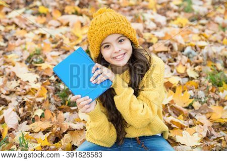 Born To Read. Happy Child Hold Book Sitting On Autumn Leaves. School Library. Reading And Literacy E