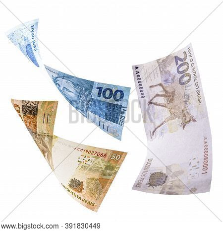 Two Hundred, One Hundred And Fifty Reais Notes In Fall, Isolated White Background. Concept Of Big Lo