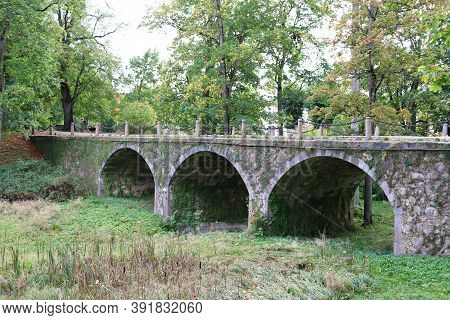 Very Old Stone Bridge In The Park Next To The Manor In The Latvian Kazdanga In October 2020