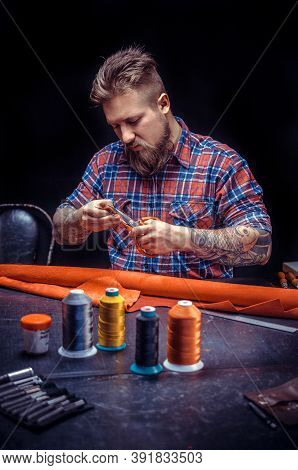 Craftsman Focusing On His Work At A Workshop