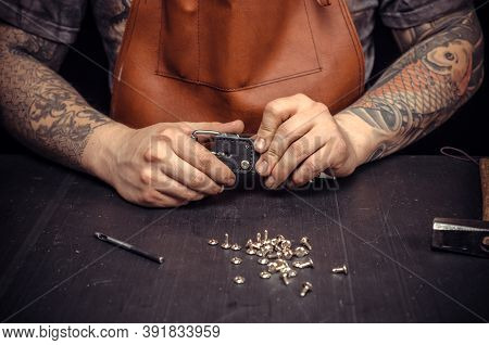 Leather Cutter Demostrating Leather Cutting Process At The Work Area