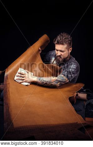Leather Artist Working On A New Leather Product In Leather Studio