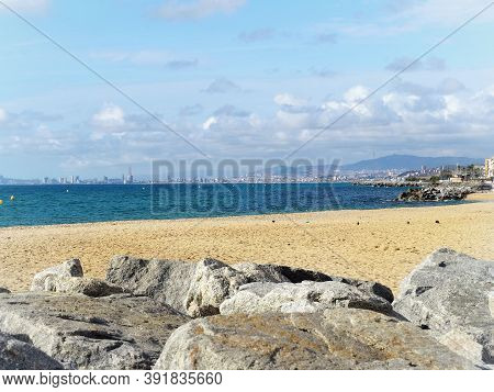Barcelona Skyline And Sailingboat In Mediterranean Sea