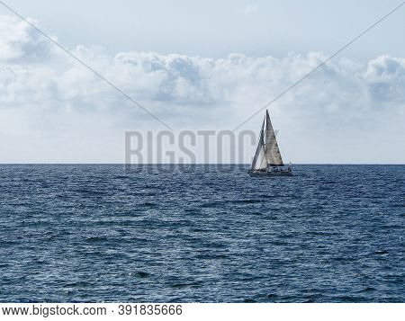 Barcelona Skyline And Sailingboat In Mediterranean Sea
