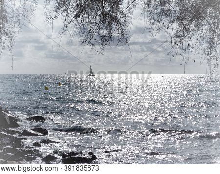 Barcelona Skyline And Sailingboat In Mediterranean Sea