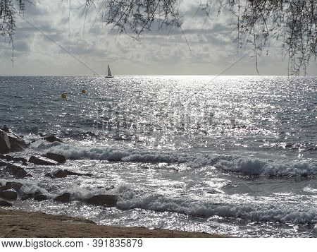 Barcelona Skyline And Sailingboat In Mediterranean Sea