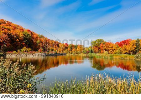 Gorgeous, Magnificent View Of A Little Lake With Beautiful  Vibrant Colorful Autumn Forest Landscape