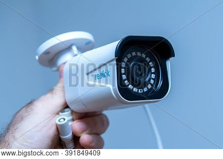 Paris, France - Oct 24, 2020: Pov Male Hand Holding Showing New Reolink Cctv Surveillance Model Rlc-