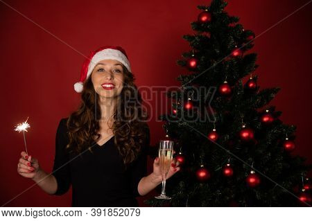 Beautiful Long-hair Brunette Girl In Santa Claus Hat Takes Christmas Greetings Online With Burning S