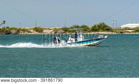 Port Aransas, Tx - 28 Feb 2020: Fast Moving Fishing Boat With Outboard Motor On The Water, On A Sunn