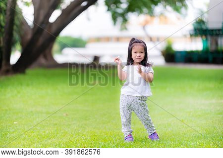 Asian Cute Girl Is Holding Used Tissue Paper In Her Hand. Little Girl Dressed In White Took Walk In 