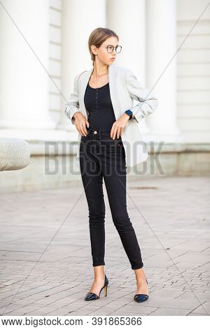 Full length portrait of a young beautiful girl in a business jacket