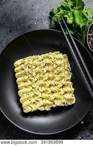 Dry, Raw Quick Cooking Noodle, Instant Noodles. Black Background. Top View