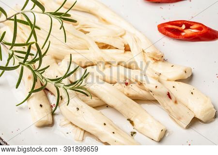 Cheese In Marinade With Olive Oil, Chili And Rosemary, Food Recipe Background. Close Up