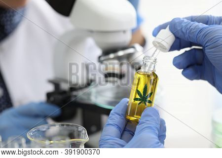 Chemical Scientists Examine Composition Of Hemp Extract Under Microscope In Chemical Laboratory Clos