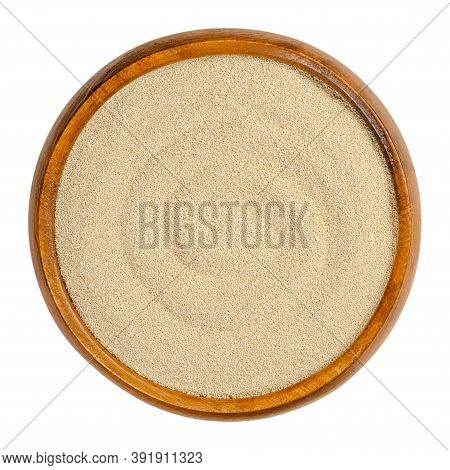Dry Yeast In A Wooden Bowl. Small Oblong Granules Of Active Bakers Yeast, Commonly Used In Baking Br