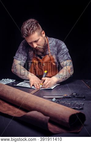 Professional Tanner Focusing On His Work In Workshop