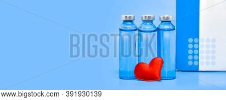 Glass Medical Ampoules And A Red Heart On A Light Blue Background. Health Concep: Medicine, Saving L