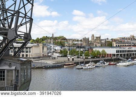 Bristol, Uk - May 11, 2012: The Harbourside And Clifton With A Preserved Dockside Crane In Foregroun