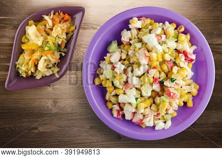 Crab Salad On Purple Plate With Vegetaible Salad Top View. Crabs Salad On Brown Wooden Background