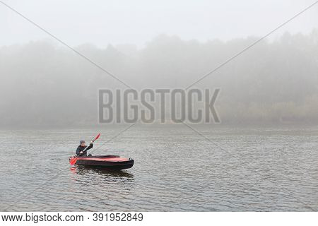 Simple Dugout Canoe On Lake, Young Athlete Rowing Boat In Autumn Cloudy Day, Guy In Black Jacket Can