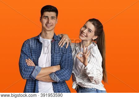 Gestures And Emotions Of Young People. Smiling Couple Looking At Camera, Guy With Crossed Arms On Hi